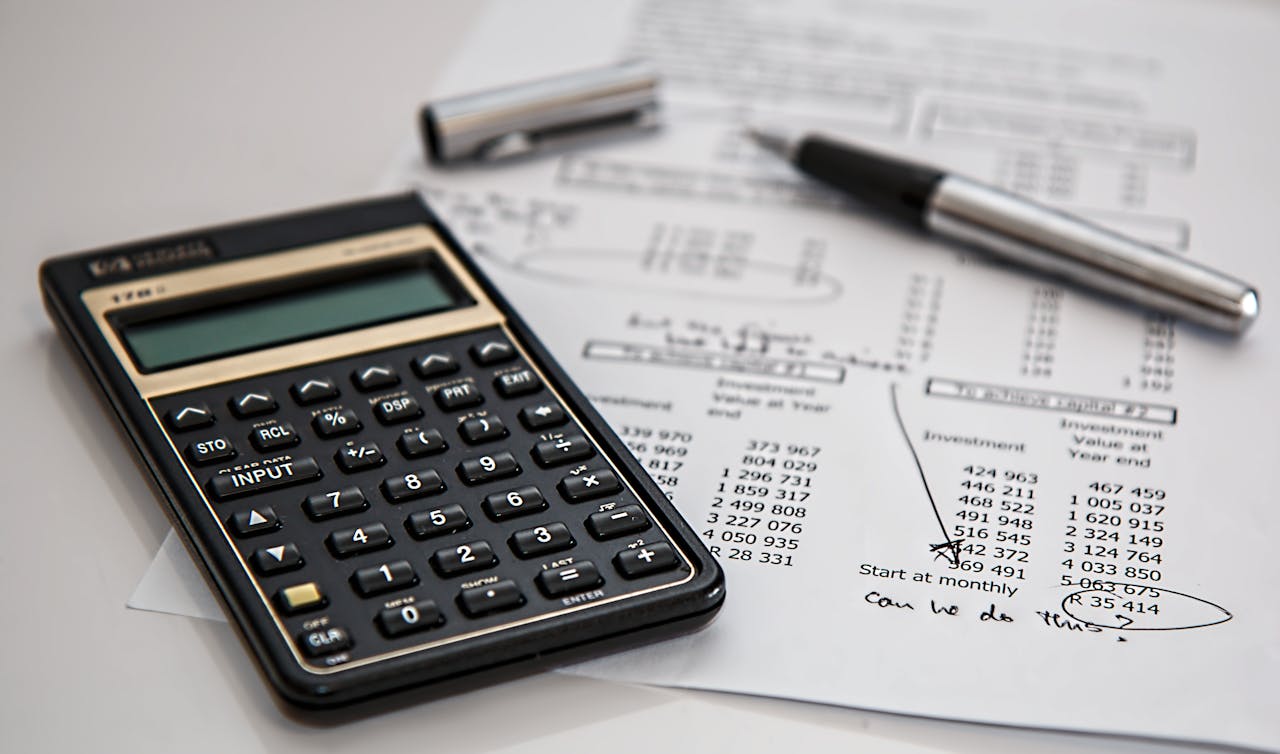 services-03 Close-up of financial documents with calculator and pen, ideal for business management themes.