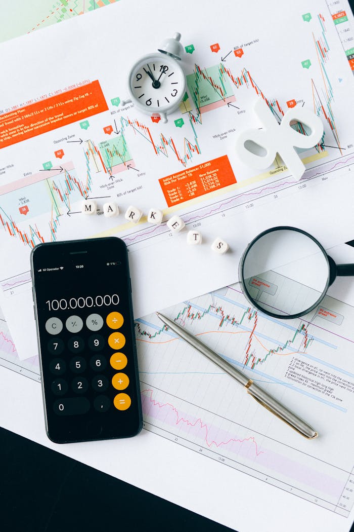 who-we-are Flat lay of charts, calculator, and magnifying glass on office desk for market analysis.