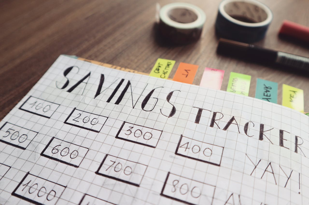 services-02 Close-up of a handmade savings tracker with colored tabs on a wooden table, ideal for financial planning visuals.